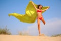 Young girl with yellow fabric shawl in hands