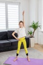 Child Girl Doing Yoga Stretch at Home