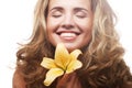 Young girl with yellow lily laughs Royalty Free Stock Photo