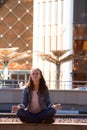 young girl yoga and meditates in the lotus position in a big city Royalty Free Stock Photo