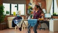 Young girlfriend enjoying doing ironing work at home Royalty Free Stock Photo