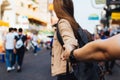 Young girlfriend tourist holding hand of boyfriend