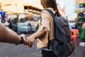 Young girlfriend tourist holding hand of boyfriend