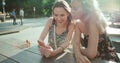 Beautiful young women watching photos on a mobile phone. Royalty Free Stock Photo