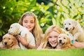 Young Girls with Baby Puppies Royalty Free Stock Photo