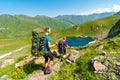 Young girls backpacking towards a lake in Greater Caucasus mount