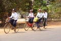 Young girls bicycle home from school