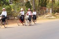 Young girls bicycle home from school