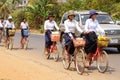 Young girls bicycle home from school