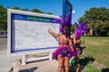 Young girls in Caribana costume looking at the parade route map for directions