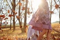 Young girls children kids playing running in fallen autumn leave