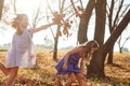 Young girls children kids playing running in fallen autumn leave Royalty Free Stock Photo