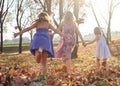 Young girls children kids playing running in fallen autumn leave Royalty Free Stock Photo