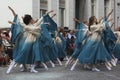 Young girls dancing in the street in front of the public