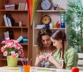 Young girls drawing pictures at home