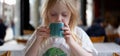 Young girls enjoy hot beverage in a cafe.