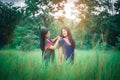 Young girls enjoy playing in the mist of forest outdoor at countryside of Thailand Royalty Free Stock Photo