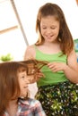 Young girls enjoying combing hair