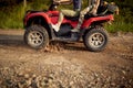 Young girls enjoying a quad ride on a muddy road in the nature. Riding, nature, friendship, together