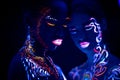 Young girls with fluorescent make-up posing at camera Royalty Free Stock Photo