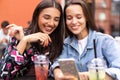 Young girls friends watch something in smartphone. Royalty Free Stock Photo