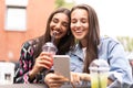 Young girls friends watch something in smartphone. Royalty Free Stock Photo