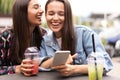 Young girls friends watch something in smartphone. Royalty Free Stock Photo