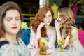 Young girls gossip behind the back of a friend. The concept of lifestyle, gossip, lies, friendship Royalty Free Stock Photo