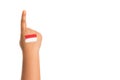 Young girls hand only pointing one finger up `number 1` with the Indonesian flag painted on her hand.