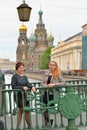 Young girls are on Italian bridge across the Griboyedov Canal in Royalty Free Stock Photo