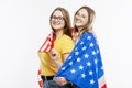 Young girls in jeans hold the American flag, hug and laugh. Celebrating Independence Day and patriotism. Isolated on a white