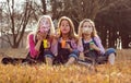 Young girls kids sisters blowing bubbles with soap in a farm fie