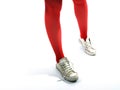 Young girls legs in red tights and old sneakers Royalty Free Stock Photo