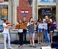 Young girls play violin on the streets of Munich center