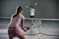 Young girls playing tennis game indoor
