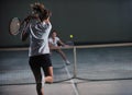 Young girls playing tennis game indoor