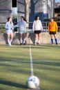 Young girls ready for playing football on green field