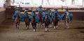 Group of female riders in blue dress