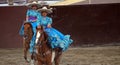 Female riders in blue dress