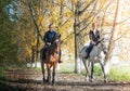 Young girls riding on horseback through the forest Royalty Free Stock Photo