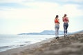 Young girls running on the beach Royalty Free Stock Photo