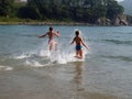 Young girls running to the sea