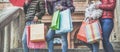 Young girls with shopping bags during sale times before winter holidays - Millennials women having fun buying clothes and Royalty Free Stock Photo