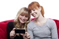 Young girls showing something on cell phone Royalty Free Stock Photo