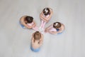 Young girls sit on the floor in a choreography class