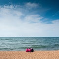 Young girls sitting on the shore of the lake Baikal in the summer.