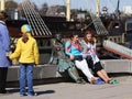 Young girls sitting at the statue on the waterfront