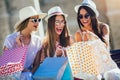 Young girls walking the street with shopping bags. Happy shopping with smiles Royalty Free Stock Photo