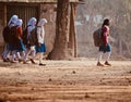 Young girls are walking together to attend the village school