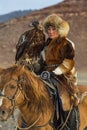 Young Golden Eagle Huntress during hunting with birds of prey to the hare in desert mountain of Western Mongolia.